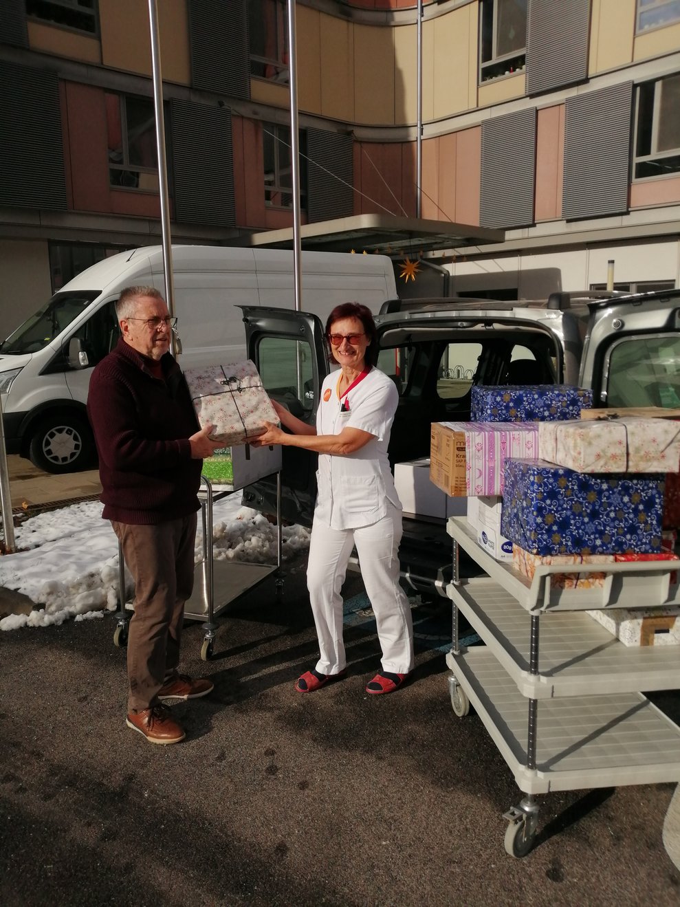 Wir übergeben die Geschenkkartons. 